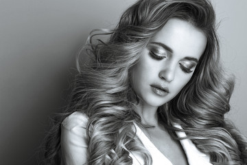 Naklejka premium Beauty portrait of adorable lady with long wavy hair