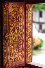  Laos  style beautiful vintage gold painted windows  at Wat Xieng Thong Luang Prabang Laos