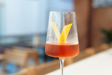 Yellow cocktail with lemon zest