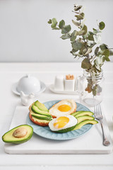 Toast with avocado, fried egg, top view