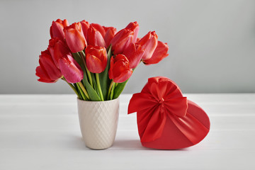 Red tulip flower and gift box isolated on white background.