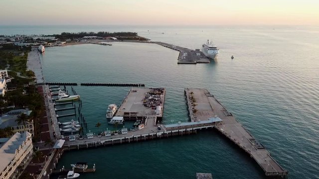 Beautiful 4K panning aerial drone shot of Mallory Square in Key West, Florida during sunset.