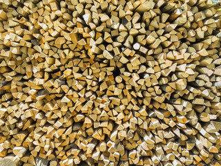 Small pieces of firewoods neatly stacked as combustible for winter