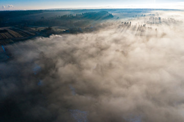 Foggy winter morning in mountain village with top view