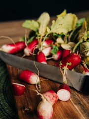 Radishes on cutting board with knife