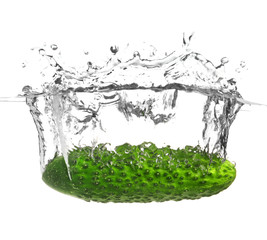 Falling of fresh cucumber into water against white background