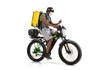 Fototapeta na wymiar Too much orders. Contacless delivery service during quarantine. Man delivers food during isolation, wearing helmet and face mask. Taking food on bike isolated on white background. Safety. Hurrying up.