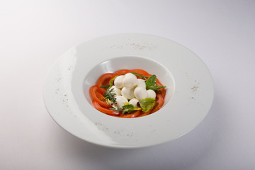 White buffalo mozzarella cheese with red tomatoes