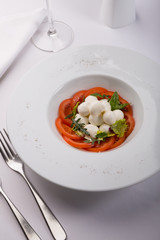 White buffalo mozzarella cheese with red tomatoes