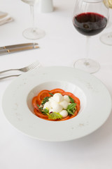 White buffalo mozzarella cheese with red tomatoes