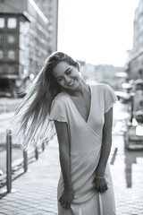 Positive girl wears fashionable dress at the street