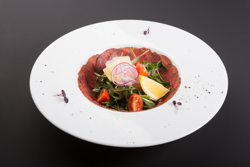 Prosciutto salad of smoked raw meat