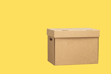 Cardboard box isolated on a yellow background. Carton Packaging Box. Donation box