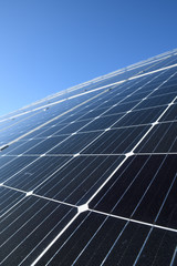 Obraz premium Solar panels against blue sky background.Against The Deep Blue Sky in suny weather