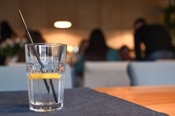 Water with lemon, drink, cocktail on the table in cafe with beautiful blurred background