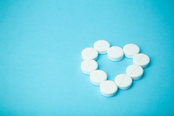 Pills background. Pills, drags and medecine concept. White tablets on a blue background