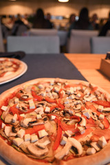 Naklejka na ściany i meble Vegetarian pizza on the table in cafe. Close-up