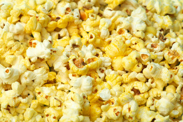 Popcorn on a colored background. Minimal food concept. Entertainment, film and video content. Aesthetics 80s and 90s concept