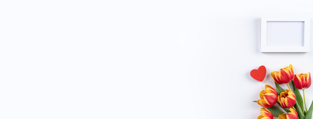 Mother's Day background, tulip flower bunch - Beautiful Red, yellow bouquet isolated on white table, top view, flat lay, mock up design concept.