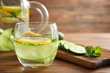 Glass of infused cucumber water on table