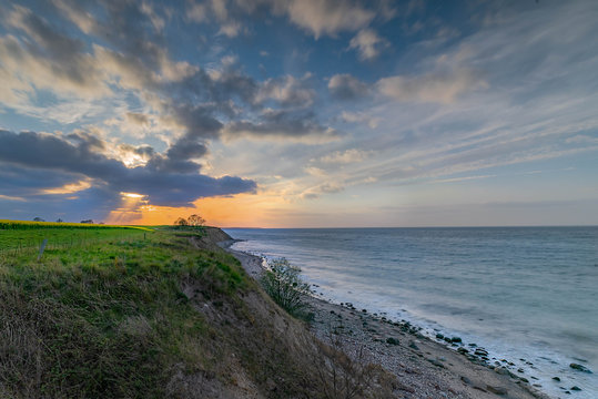 Breathtaking beautiful panorama view of wild romantic coastal cliff landscape at the Baltic Sea with rape fields in the background at the Wangels, Ostholstein,Schleswig-Holstein, Germany,
Hohwacht Bay