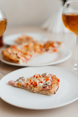 A slice of pizza on a plate close-up. Italian pizza. Home-made pizza