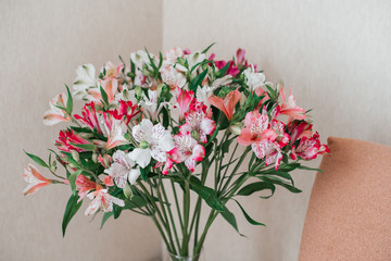 Bouquet Of Alstroemeria Flowers In Glass Vase on table. Alstroemeria flowers background. Flowers Alstroemeria.