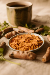 Turmeric roots and powder as background. Organic and healthy food. 