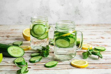Mason jars of infused cucumber water on table