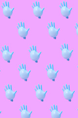 Fototapeta na wymiar Blue latex glove as balloons pattern on hot pink background.