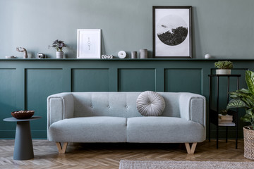 Stylish interior of living room with mint sofa, design furnitures, plants, pillow, elegant...