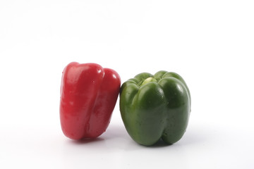 Green and red bell pepper on white background