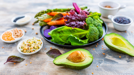 Sprouts and raw vegetables and ingredients for the healthy salad. Vegetarian food. 