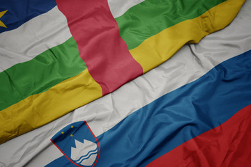 waving colorful flag of slovenia and national flag of central african republic.
