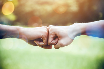 Hands of two man people fist bump team teamwork and partnership business success. Volunteer charity...