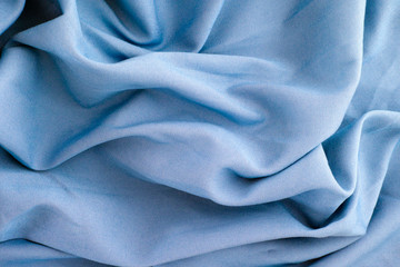 Crumpled blue textile background.