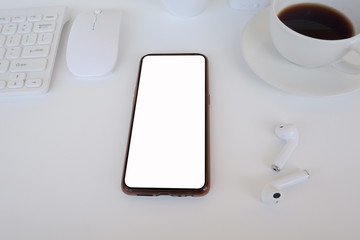 Cropped shot view of  the mobile phone with blank copy space screen for your information content or text message on the office desk, work from home.