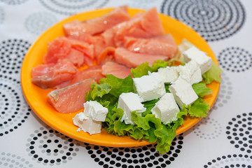 sliced salmon and cheese in the plate