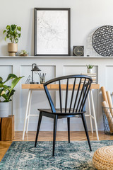 Stylish composition of home office space with sofa, wooden desk, design chair, mock up poster...