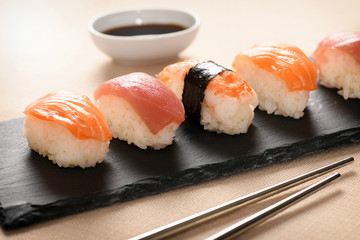 Row of fresh nighiri sushi on a black tray