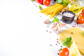 Italian food ingredients for  cooking Spaghetti Pasta. Raw spaghetti pasta with various ingredient - onion, tomatoes, garlic, basil, parsley, cheese, olive oil. On white table background, flatlay copy