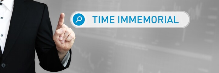 Time Immemorial. Man in a suit points a finger at a search box. The word Time Immemorial is in the search. Symbol for business, finance, statistics, analysis, economy