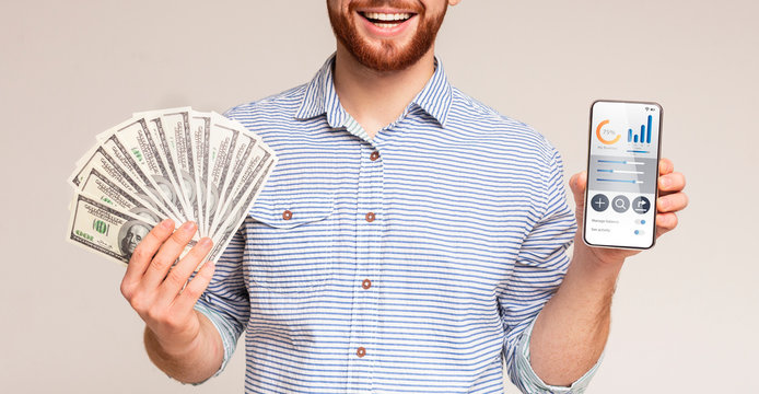 Smiling man holding money and phone with business app