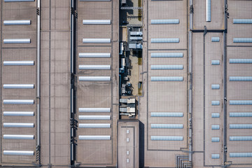 Fototapeta na wymiar Industrial. Aerial view of large roof of factory. Drone shot from above.