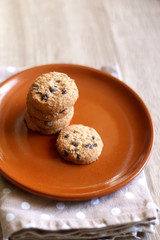 Chocolate chip cookies and polka dot napkin on wooden table. Selective focus.