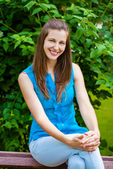 Close up portrait of beautiful young happy brunette woman with fresh and clean skin, summer street outdoors