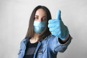 The image of the face of a young woman in a medical mask and gloves shows the LIKE symbol.