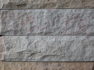 The surface of a brick stone on a concrete pillar