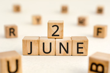 June 2 - from wooden blocks with letters, important date concept, white background random letters...