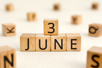 June 3 - from wooden blocks with letters, important date concept, white background random letters around